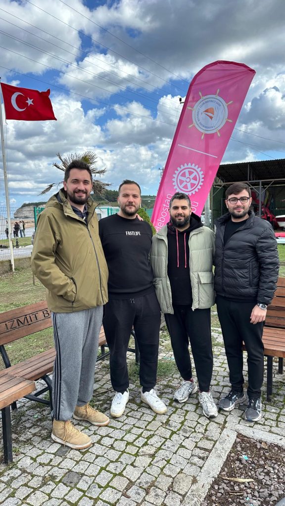 Türk bayrağı ve Rotaract bayrağı önünde dört genç