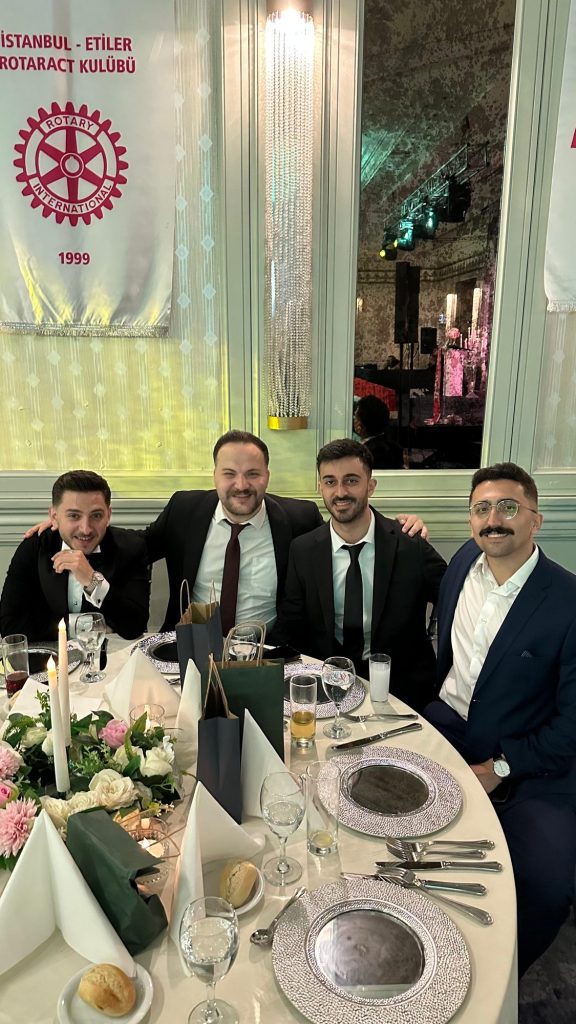 Süslü masa başında takım elbiseli konuklar